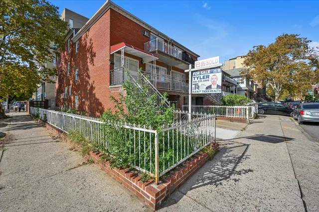 a view of a building with a small yard