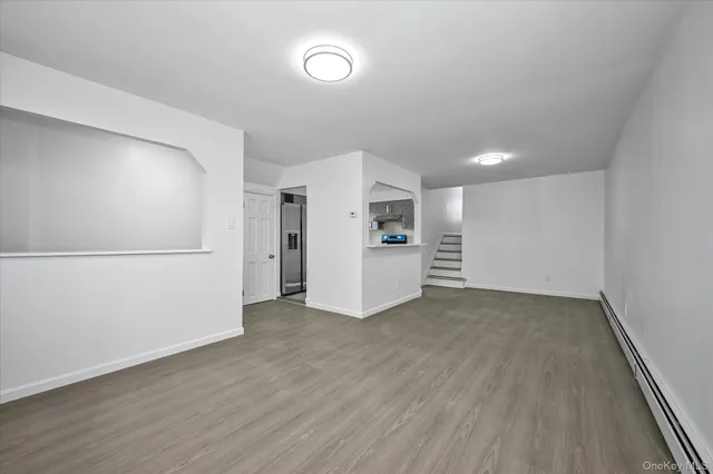 a view of a kitchen with a sink and a refrigerator