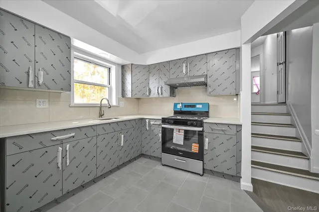 a kitchen with stainless steel appliances granite countertop a sink and a stove