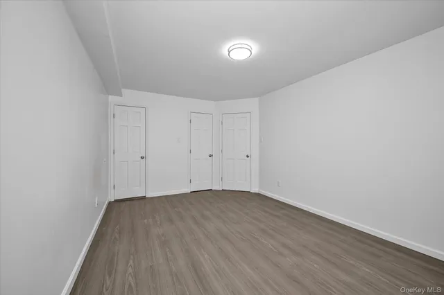 a view of room with wooden floor