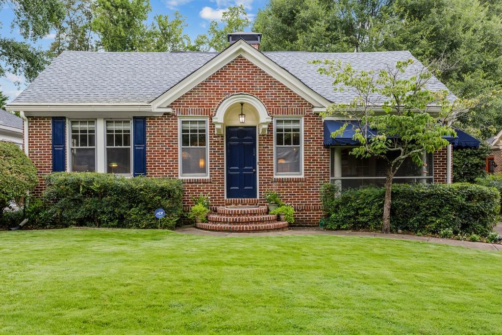 1346 Emory Road Northeast Atlanta, GA 30306 - Photo 1 of 1 a front view of a house with a garden