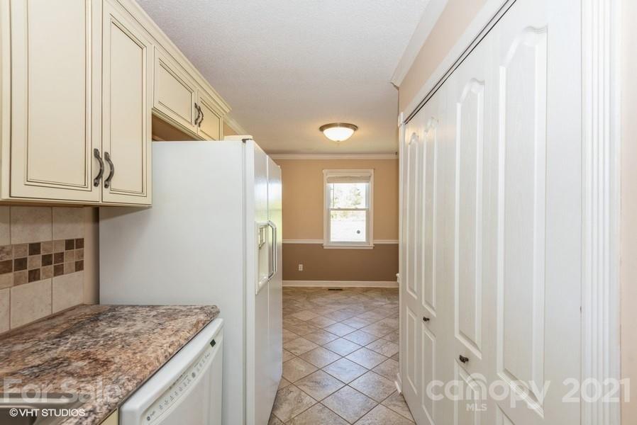 2564 Stroupe Road Clover, SC 29710 - Photo 16 of 29 a view of kitchen with granite countertop cabinets and refrigerator