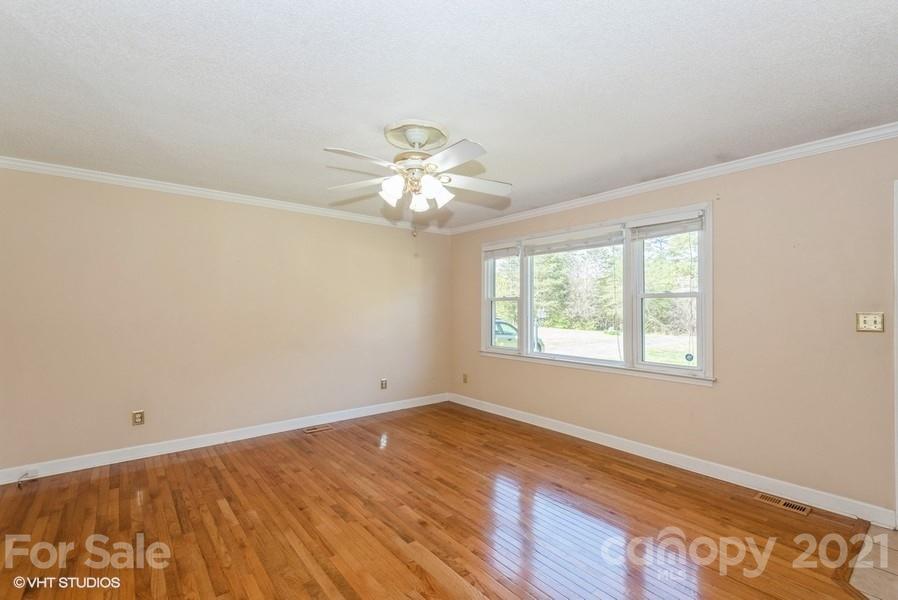 2564 Stroupe Road Clover, SC 29710 - Photo 18 of 29 a view of an empty room with wooden floor and a window