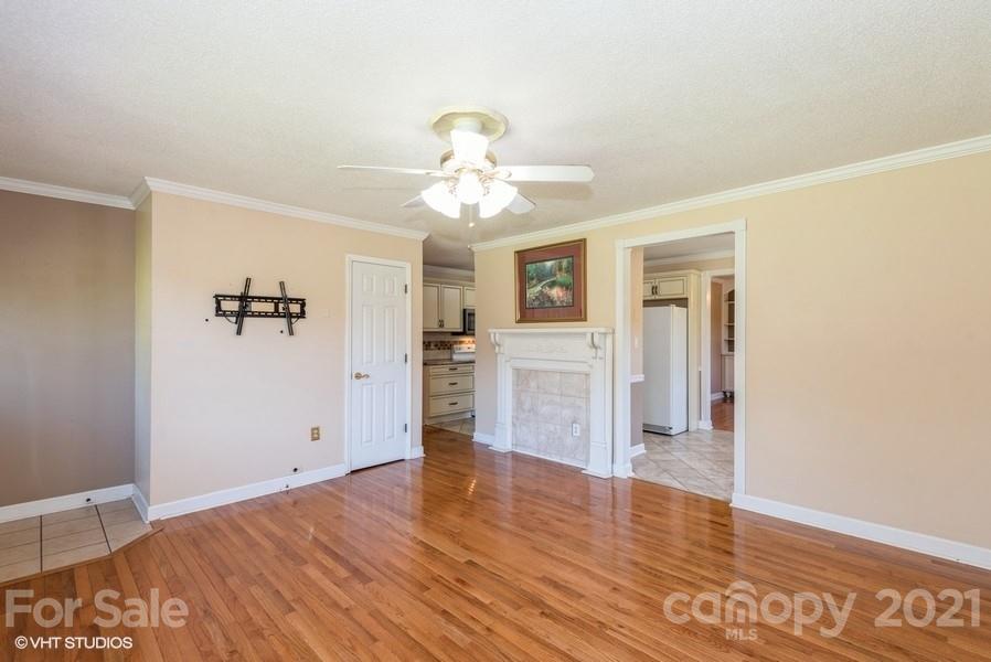 2564 Stroupe Road Clover, SC 29710 - Photo 20 of 29 a view of a kitchen with wooden floor and a ceiling fan