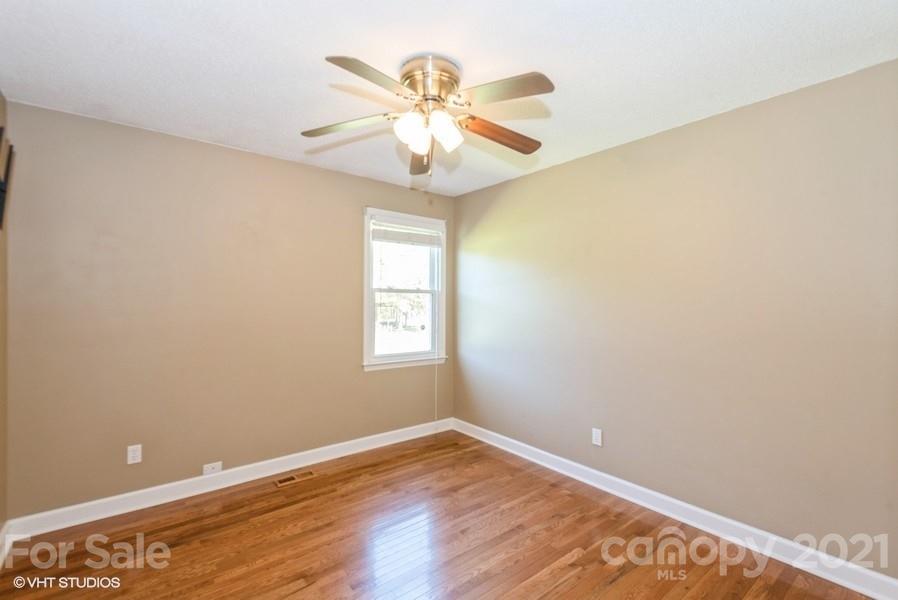 2564 Stroupe Road Clover, SC 29710 - Photo 21 of 29 an empty room with wooden floor fan and windows