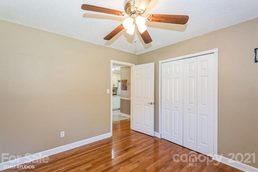 2564 Stroupe Road Clover, SC 29710 - Photo 22 of 29 wooden floor in an empty room with a chandelier fan