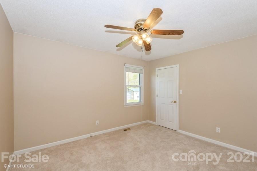 2564 Stroupe Road Clover, SC 29710 - Photo 24 of 29 an empty room with window and ceiling fan