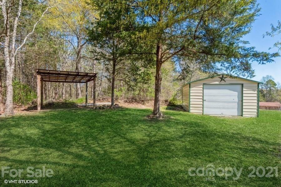 2564 Stroupe Road Clover, SC 29710 - Photo 7 of 29 a backyard of a house with plants and large tree