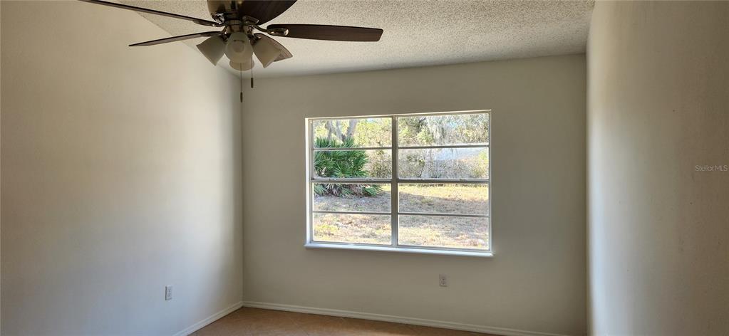 2856 Trenton Lane Deltona, FL 32738 - Photo 6 of 16 an empty room with a window and a fan