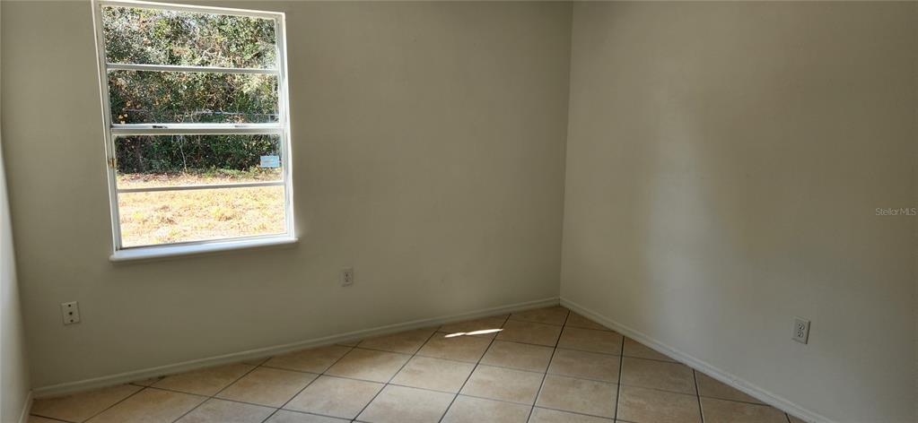 2856 Trenton Lane Deltona, FL 32738 - Photo 10 of 16 a view of an empty room with a window