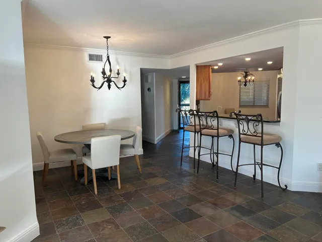 a living room with furniture ceiling fan and a window