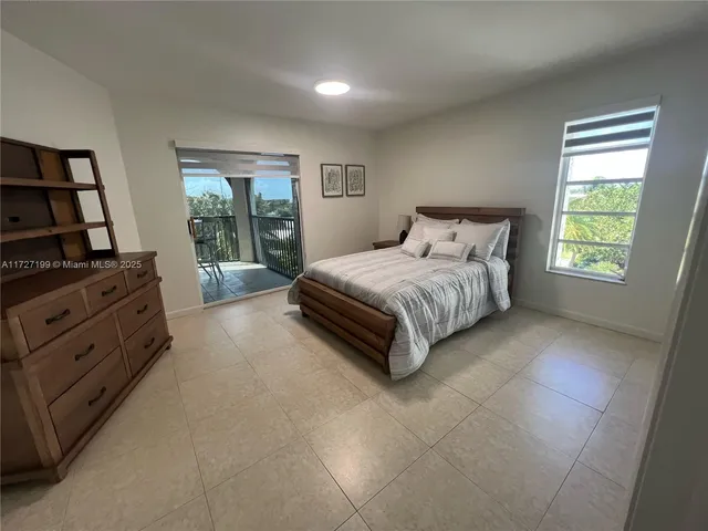 a bedroom with bed and cabinet