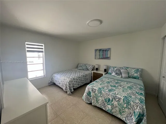 a bedroom with a bed and flat screen tv