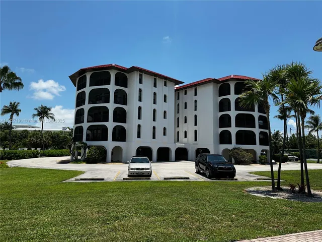 a view of a cars park in front of the house