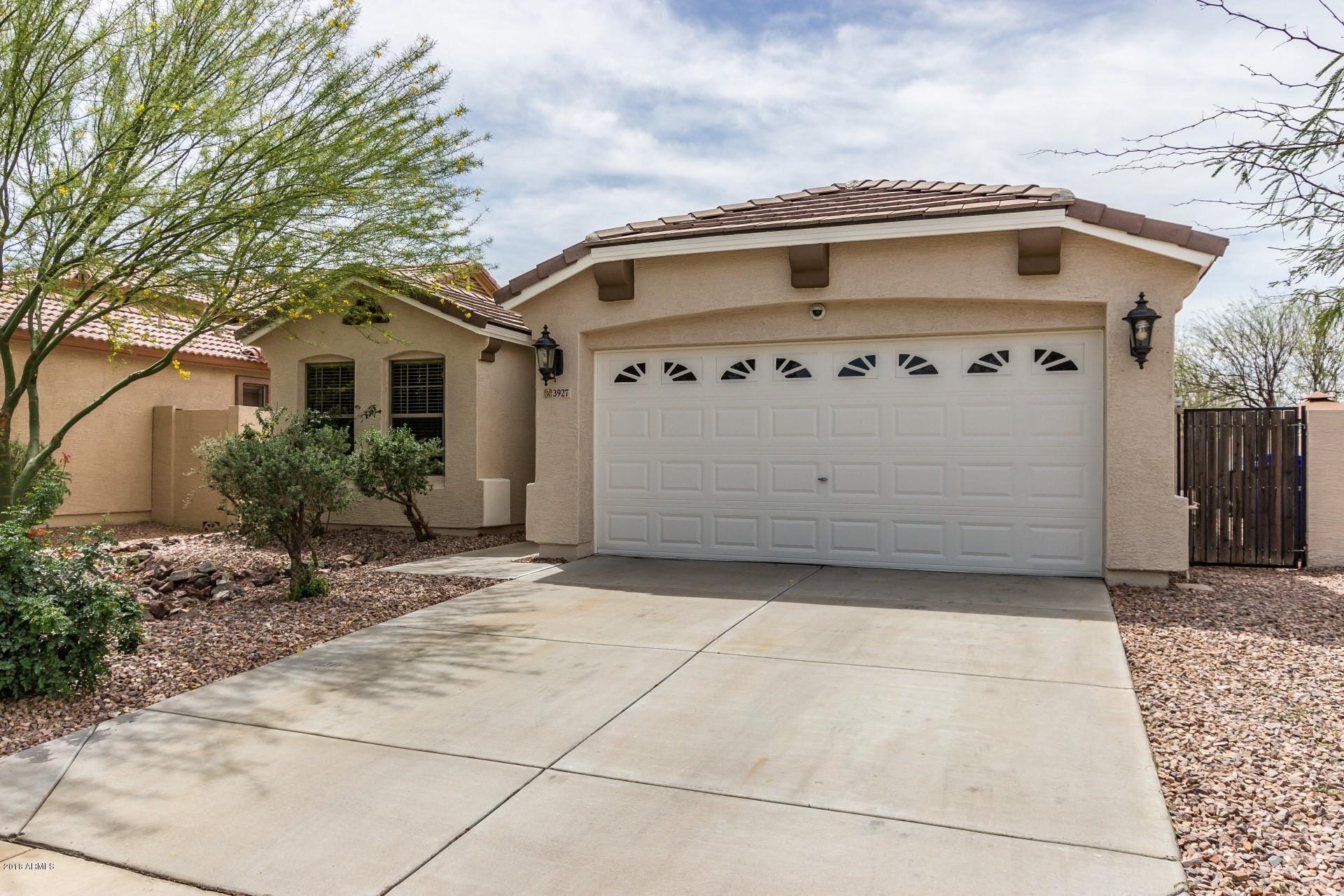 3927 East Blue Sage Road Gilbert, AZ 85297 - Photo 1 of 26 a view of a white house with a large windows