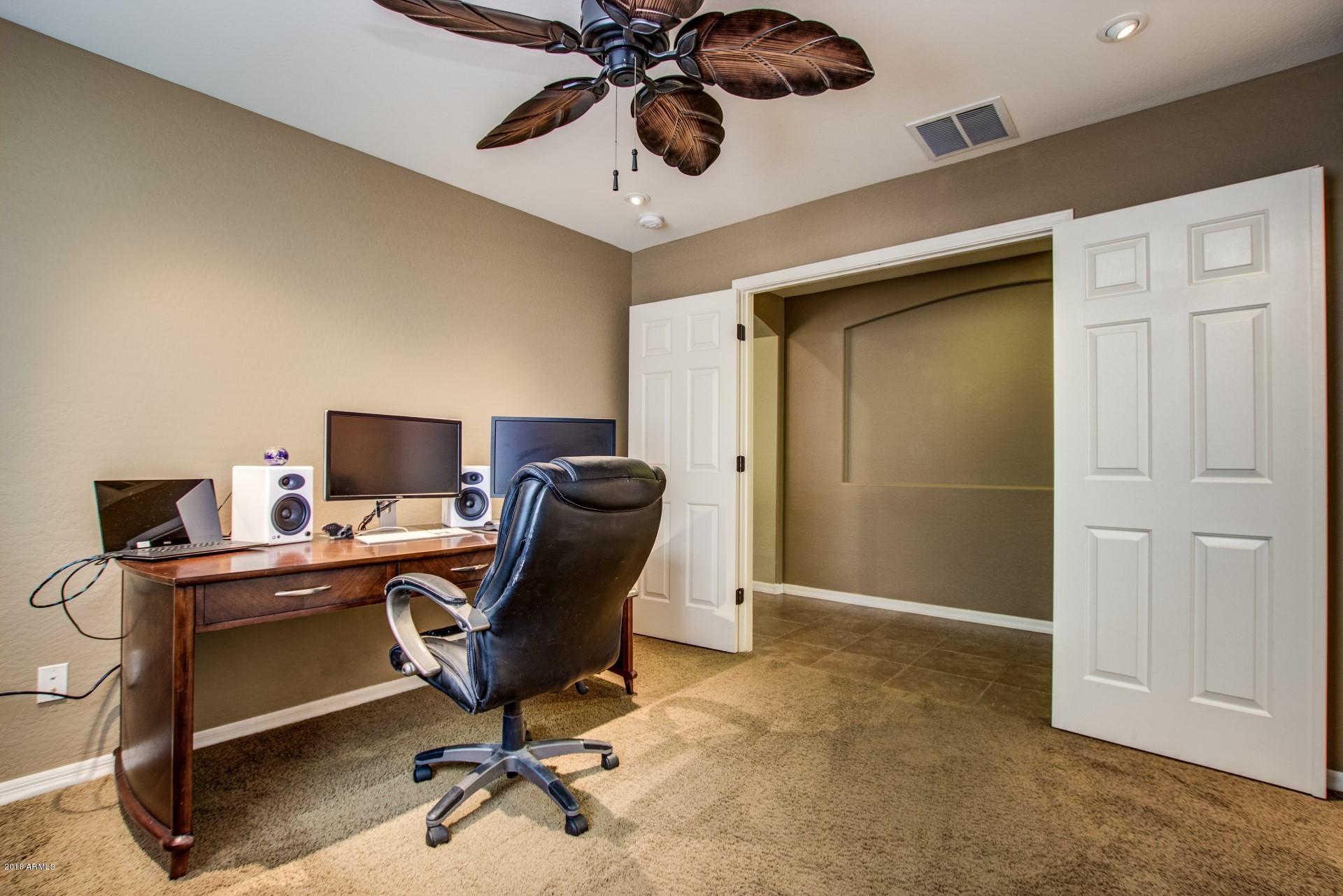 3927 East Blue Sage Road Gilbert, AZ 85297 - Photo 17 of 26 a view of a workspace with furniture