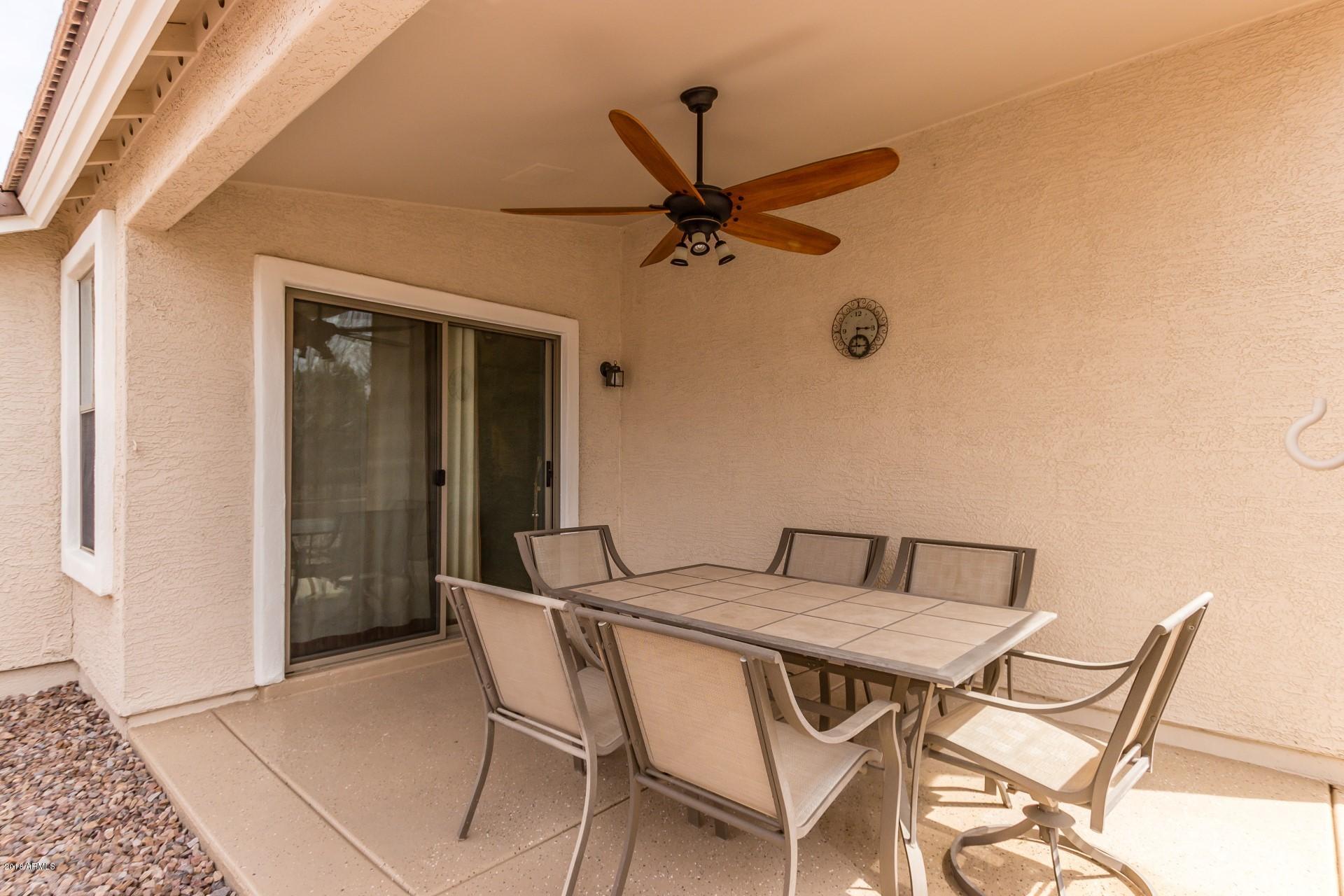 3927 East Blue Sage Road Gilbert, AZ 85297 - Photo 20 of 26 a view of a dining room with furniture and a chandelier fan