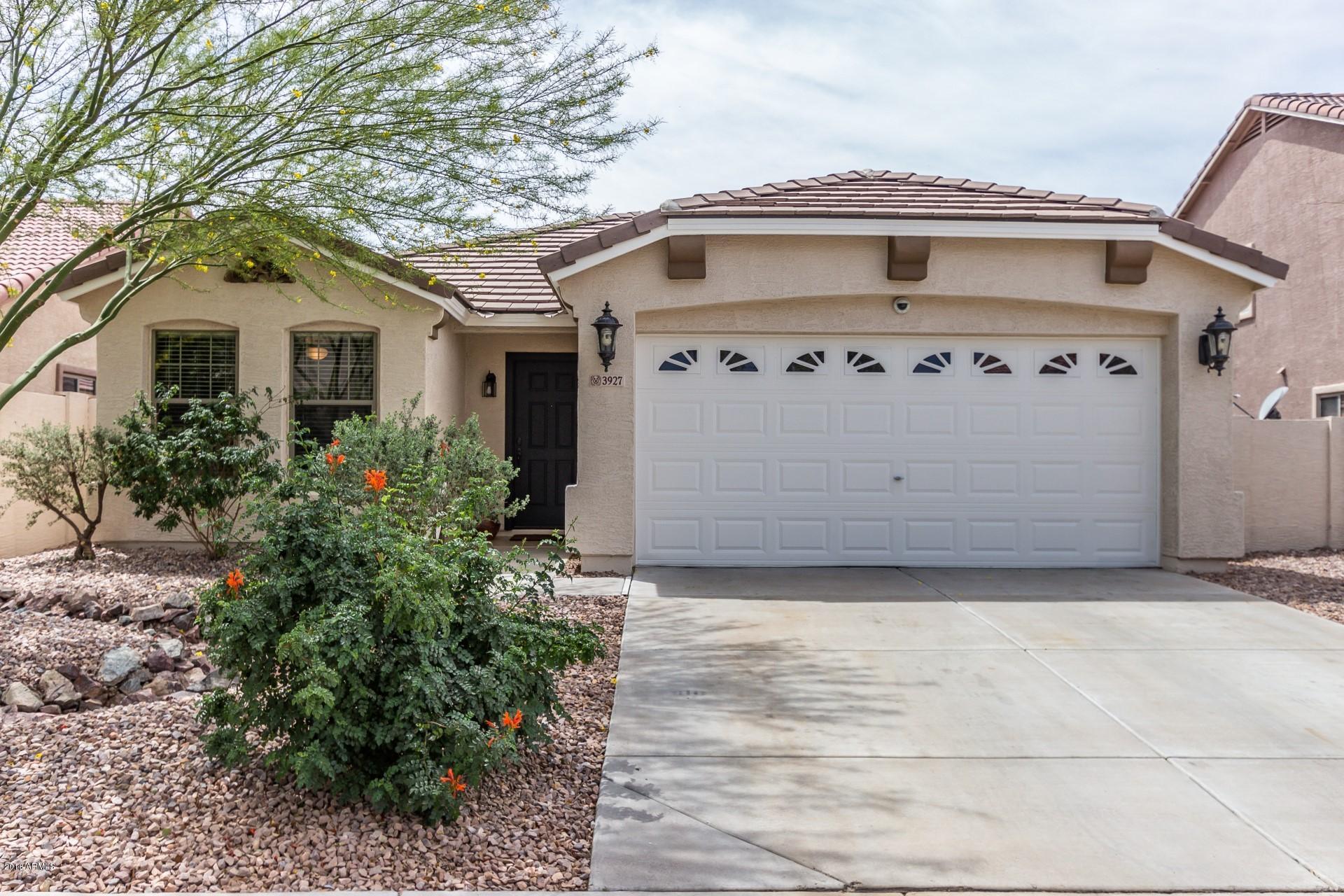 3927 East Blue Sage Road Gilbert, AZ 85297 - Photo 25 of 26 a front view of a house with a garden