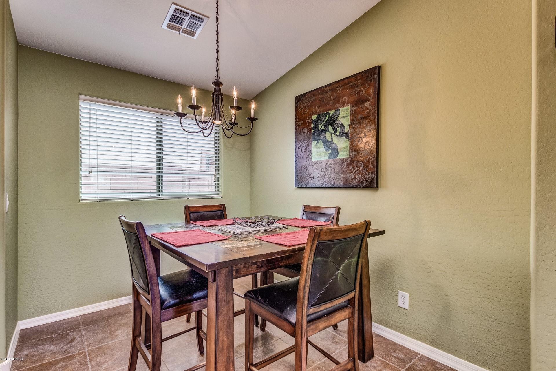 3927 East Blue Sage Road Gilbert, AZ 85297 - Photo 6 of 26 a dining room with furniture and window