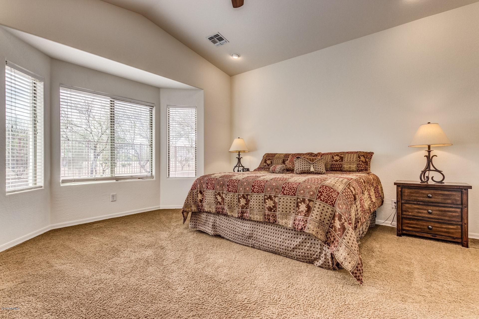 3927 East Blue Sage Road Gilbert, AZ 85297 - Photo 9 of 26 a bedroom with a bed and a window
