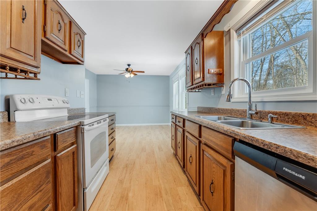 135 Virginia Street Mount Morris, PA 15349 - Photo 23 of 50 a kitchen with stainless steel appliances granite countertop a sink and a stove top oven