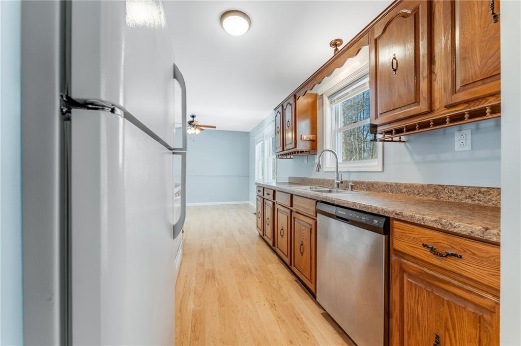 135 Virginia Street Mount Morris, PA 15349 - Photo 24 of 50 a kitchen with stainless steel appliances granite countertop a sink and wooden cabinets