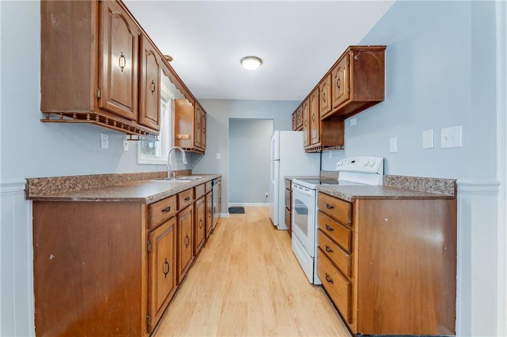135 Virginia Street Mount Morris, PA 15349 - Photo 27 of 50 a kitchen with stainless steel appliances granite countertop a sink and dishwasher a stove top oven with wooden floor