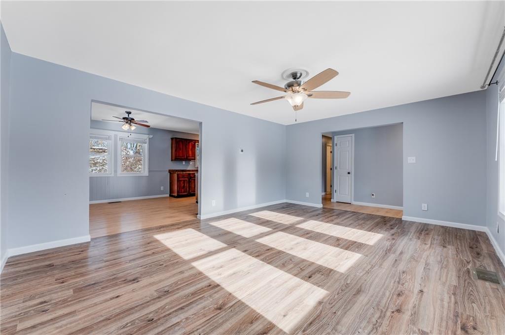 135 Virginia Street Mount Morris, PA 15349 - Photo 35 of 50 a view of a livingroom with wooden floor and a ceiling fan