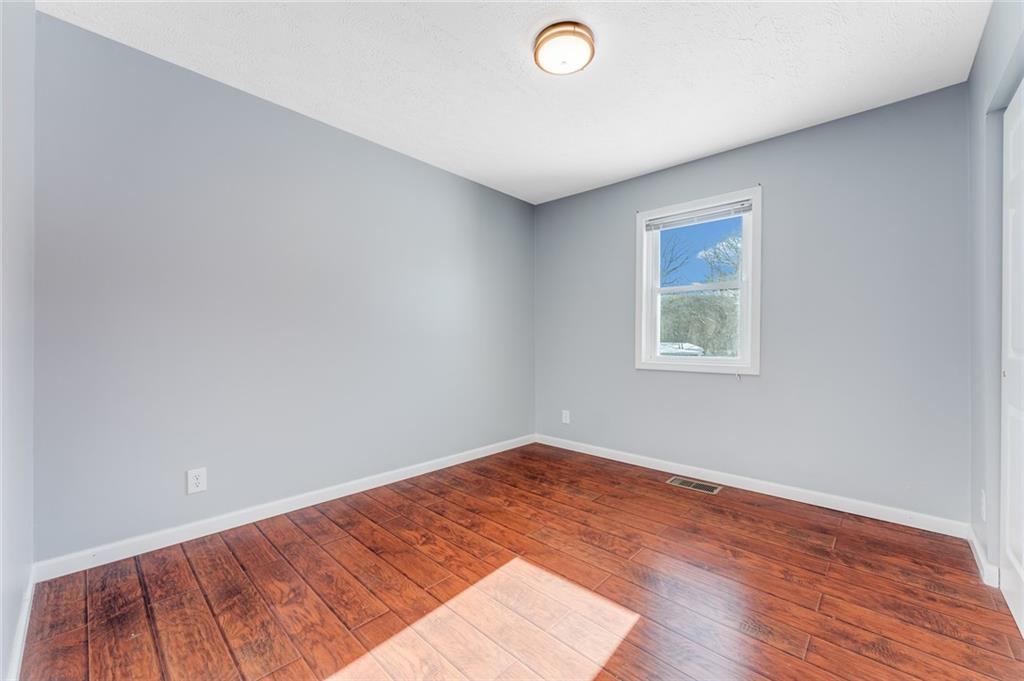 135 Virginia Street Mount Morris, PA 15349 - Photo 37 of 50 an empty room with wooden floor and windows