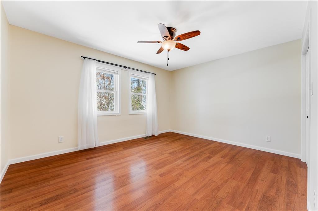 135 Virginia Street Mount Morris, PA 15349 - Photo 39 of 50 an empty room with wooden floor chandelier fan and windows
