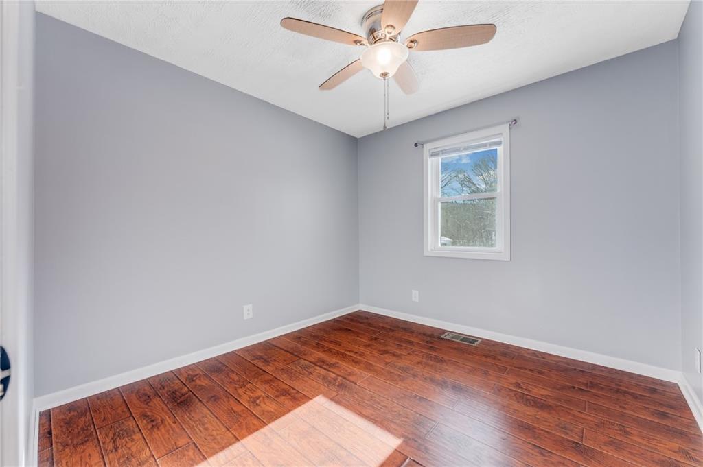 135 Virginia Street Mount Morris, PA 15349 - Photo 44 of 50 wooden floor in an empty room with a window