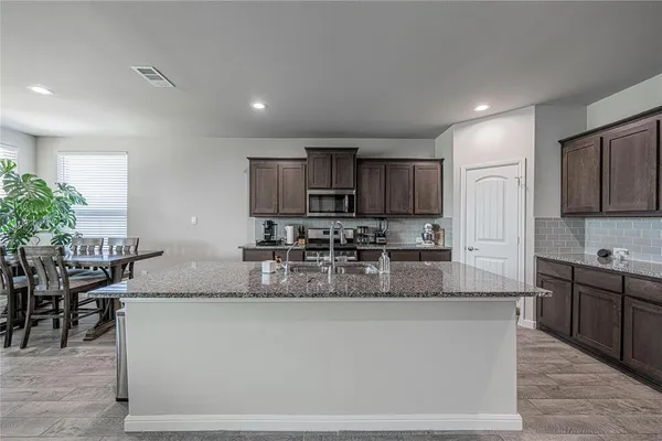 a large kitchen with granite countertop lots of counter top space