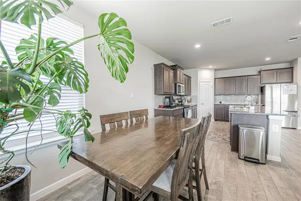 a view of a dining room with furniture and a potted plant