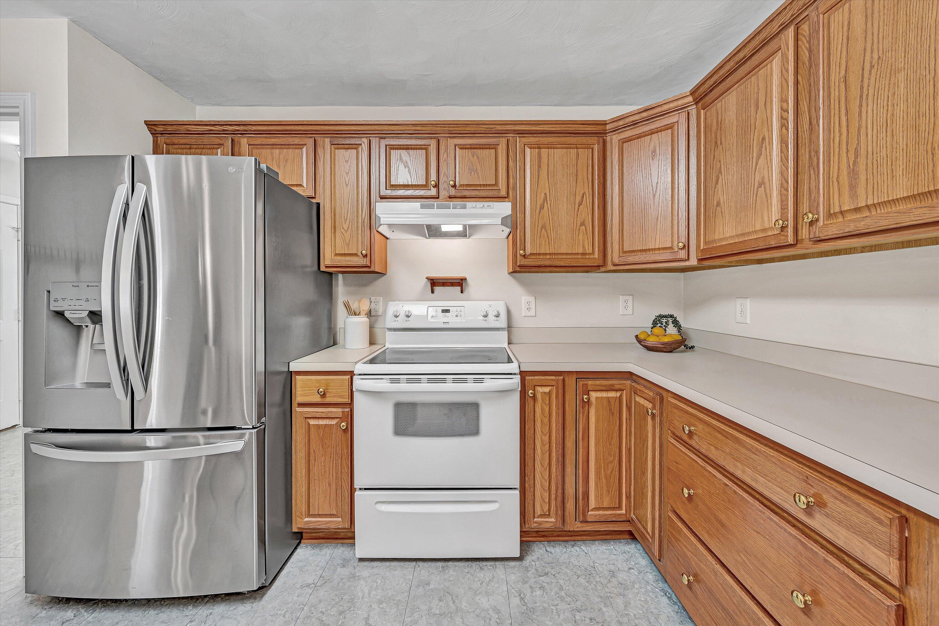 3516 Pinnacle Ridge Road Northeast Roanoke, VA 24012 - Photo 16 of 39 a kitchen with a refrigerator sink and cabinets