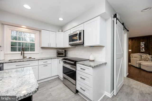a kitchen with stainless steel appliances granite countertop a stove and a sink