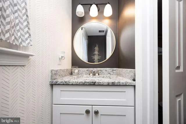 a bathroom with a mirror and a sink