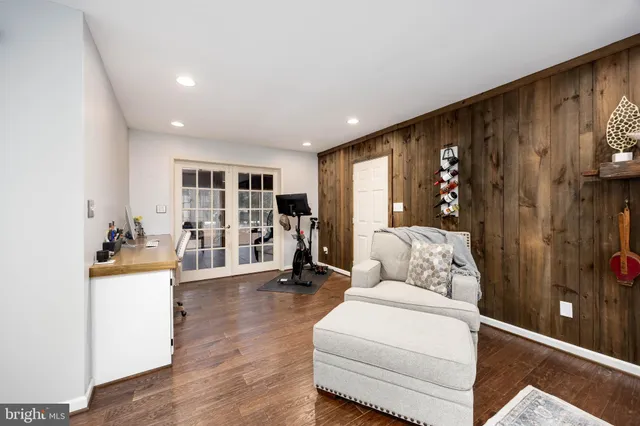 a living room with furniture and view of kitchen