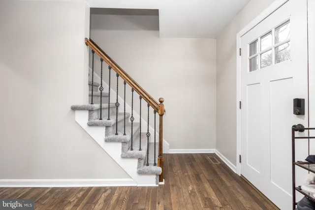 a view of entryway and hall with wooden floor