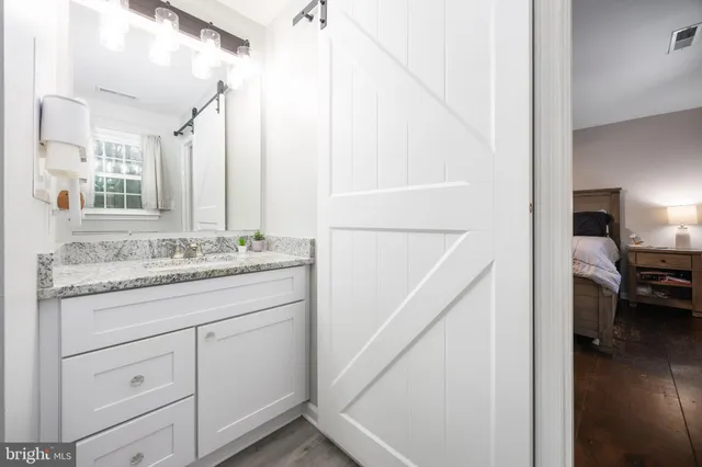 a en suite bathroom with a sink and a mirror