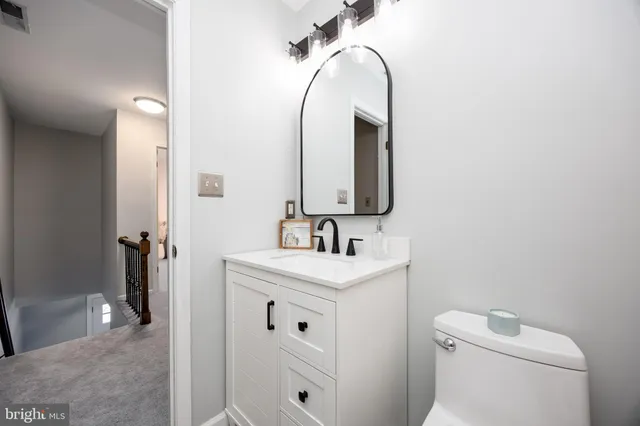 a bathroom with a toilet sink and mirror
