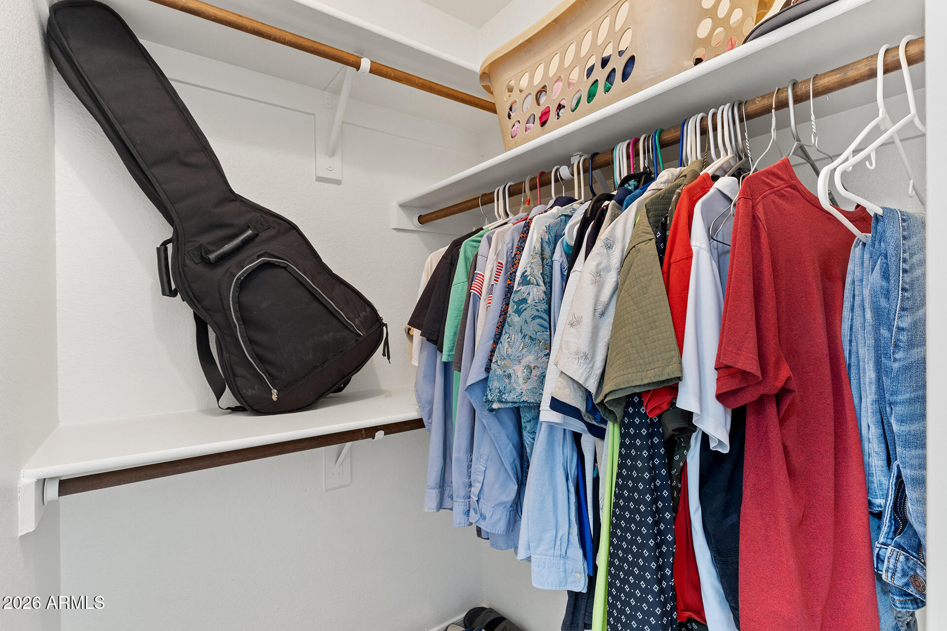 9002 West Coronado Road Phoenix, AZ 85037 - Photo 28 of 54 a view of walk in closet with clothes and shoes