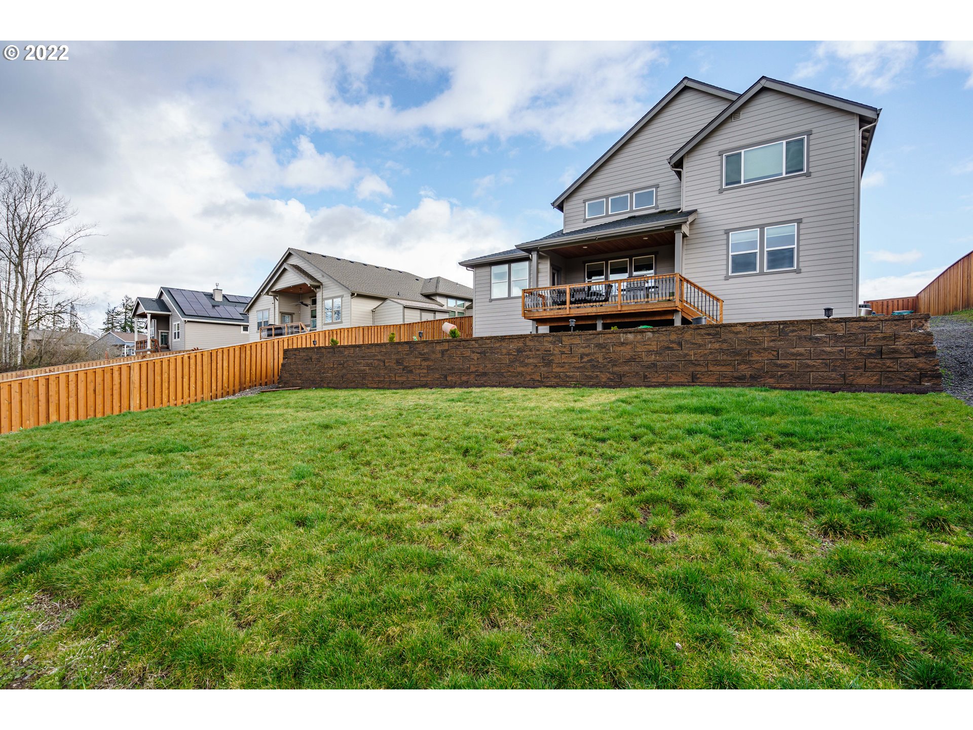 1502 South Nighthawk Road Ridgefield, WA 98642 - Photo 28 of 32 a front view of a house with a yard and trees