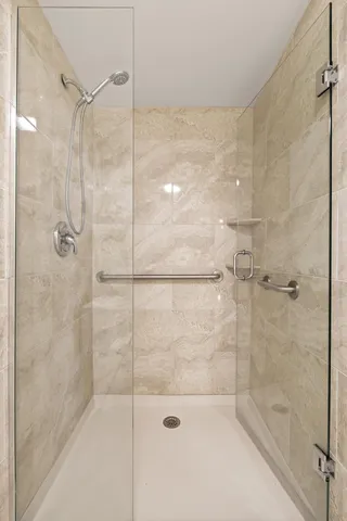 a white toilet next to a bathroom shower