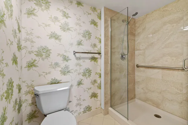 a bathroom with a glass shower door