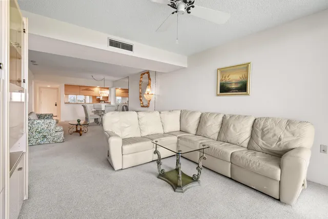 a living room with furniture a white walls and white walls