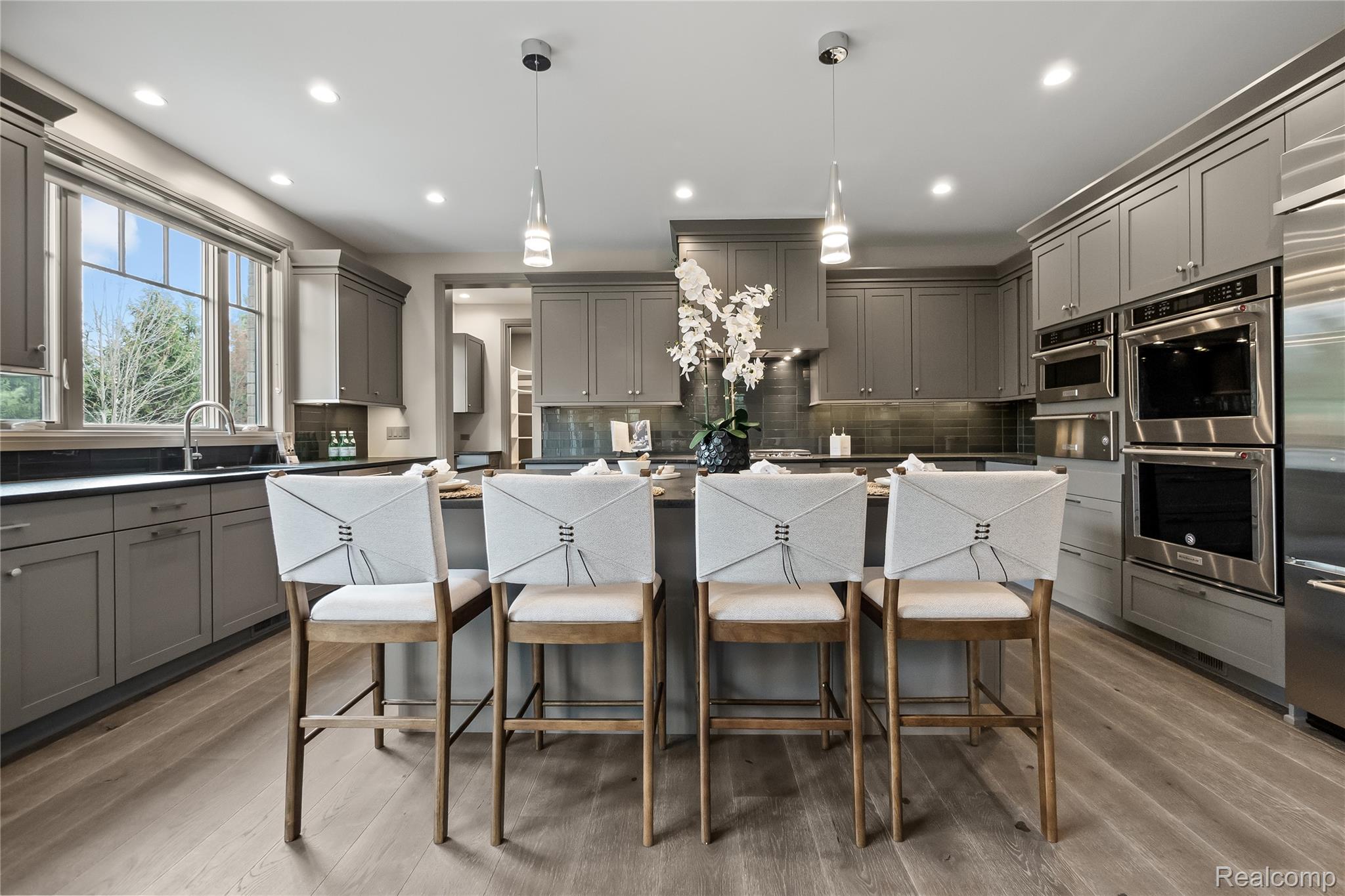 3824 Poppleton Street Troy, MI 48084 - Photo 14 of 51 Kitchen featuring gray cabinets, stainless steel appliances, a breakfast bar area, and a center island