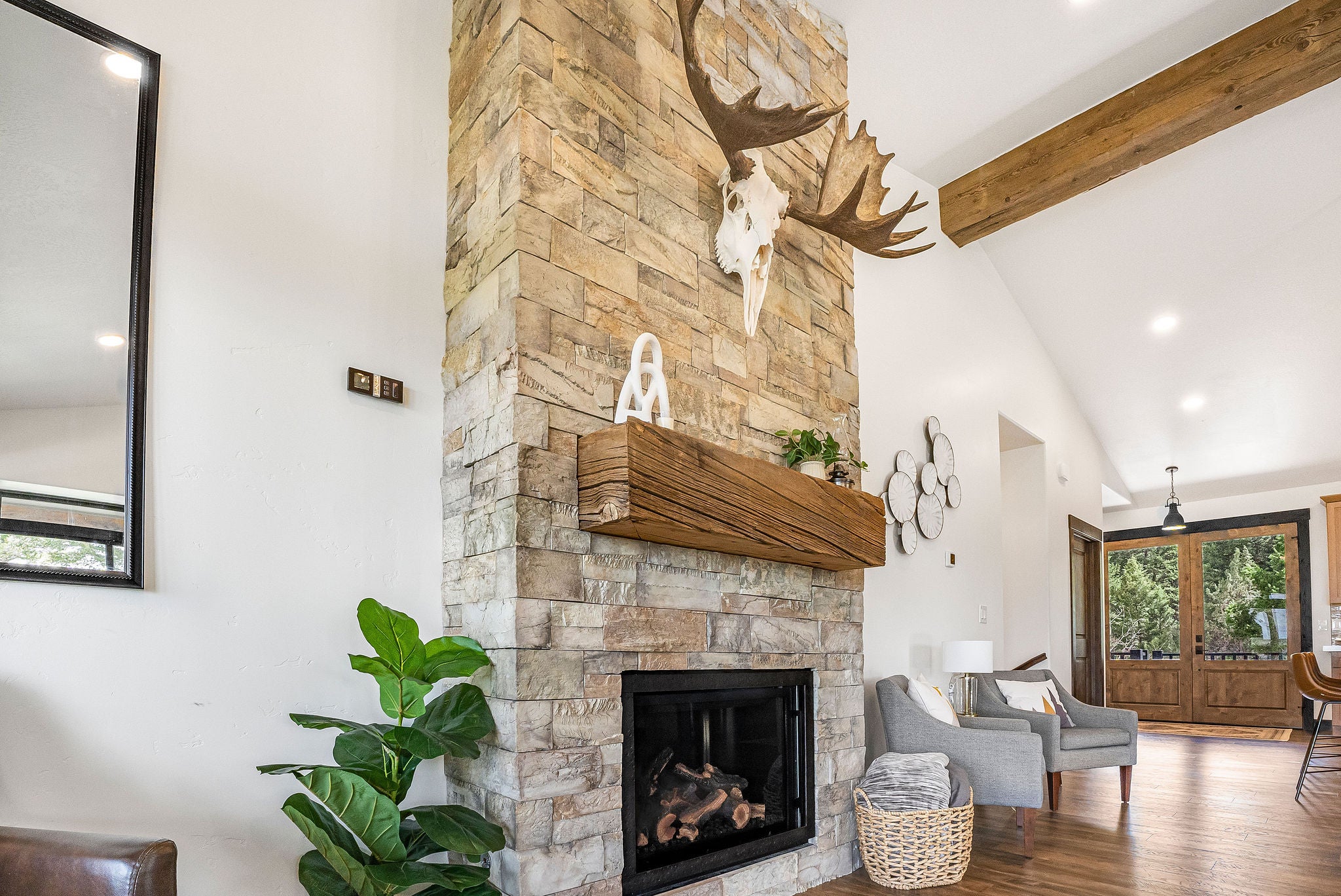 77 Rumsey Road Philipsburg, MT 59858 - Photo 24 of 76 Living room with beamed ceiling, wood finished floors, a stone fireplace, high vaulted ceiling, and recessed lighting