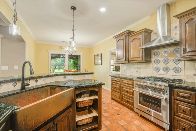 a kitchen that has a sink stove and cabinets