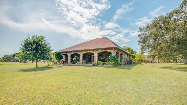 a front view of house with yard and green space