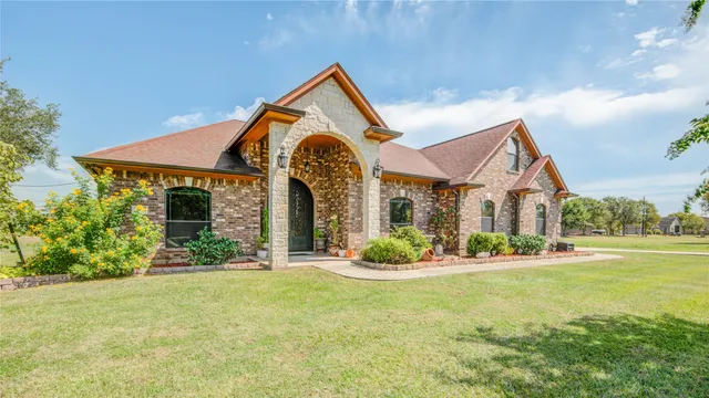 a front view of a house with garden